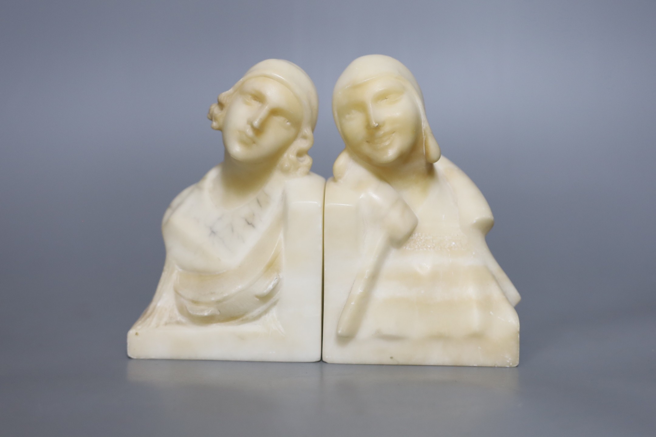 A pair of French Art Deco cream alabaster figural lady bookends, 15 cms high